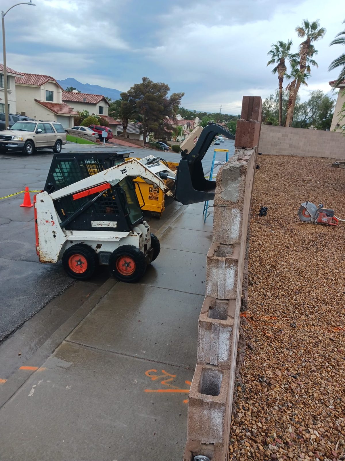 Skid steer loading demolition debris into a dump trailer