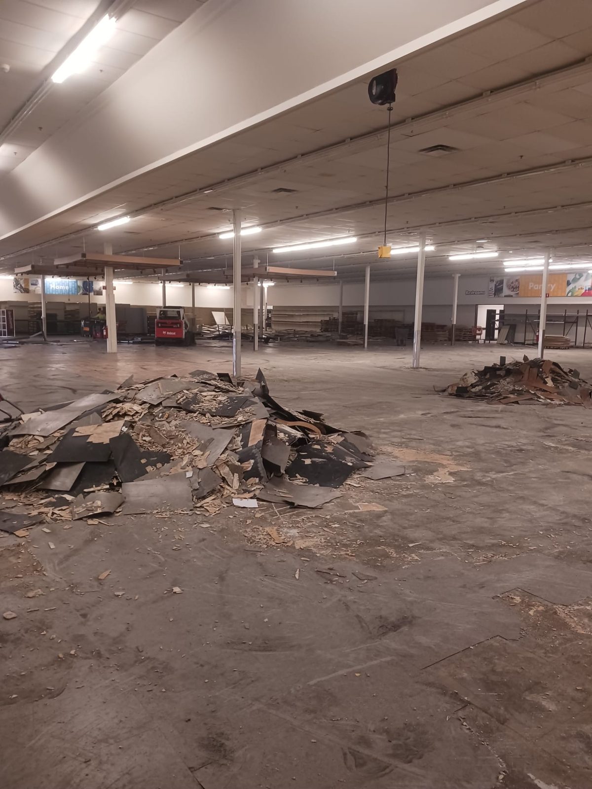 Flooring and thinset debris piled up during a commercial tear-out