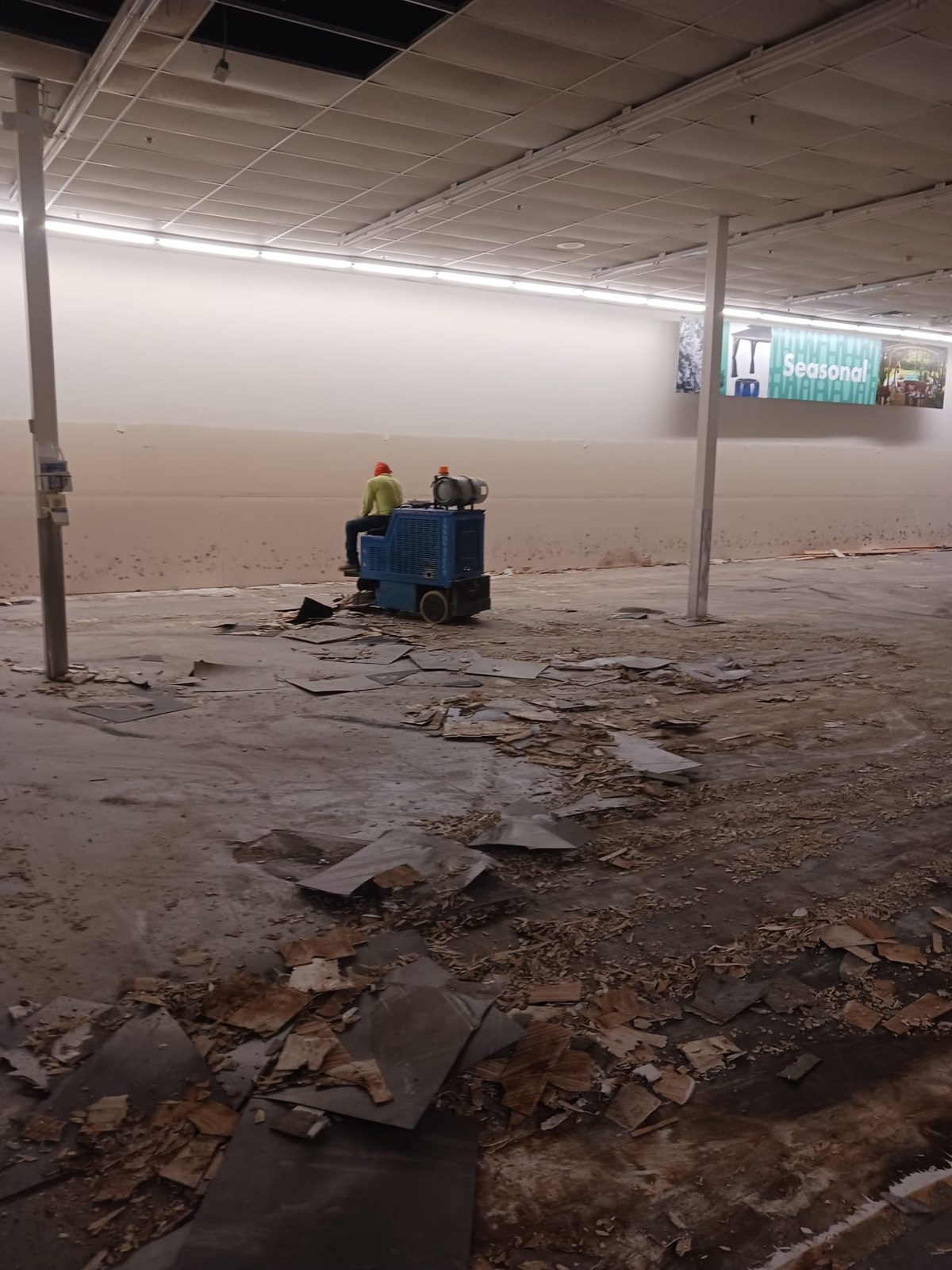 Skid steer clearing a large Las Vegas store floor down to the slab